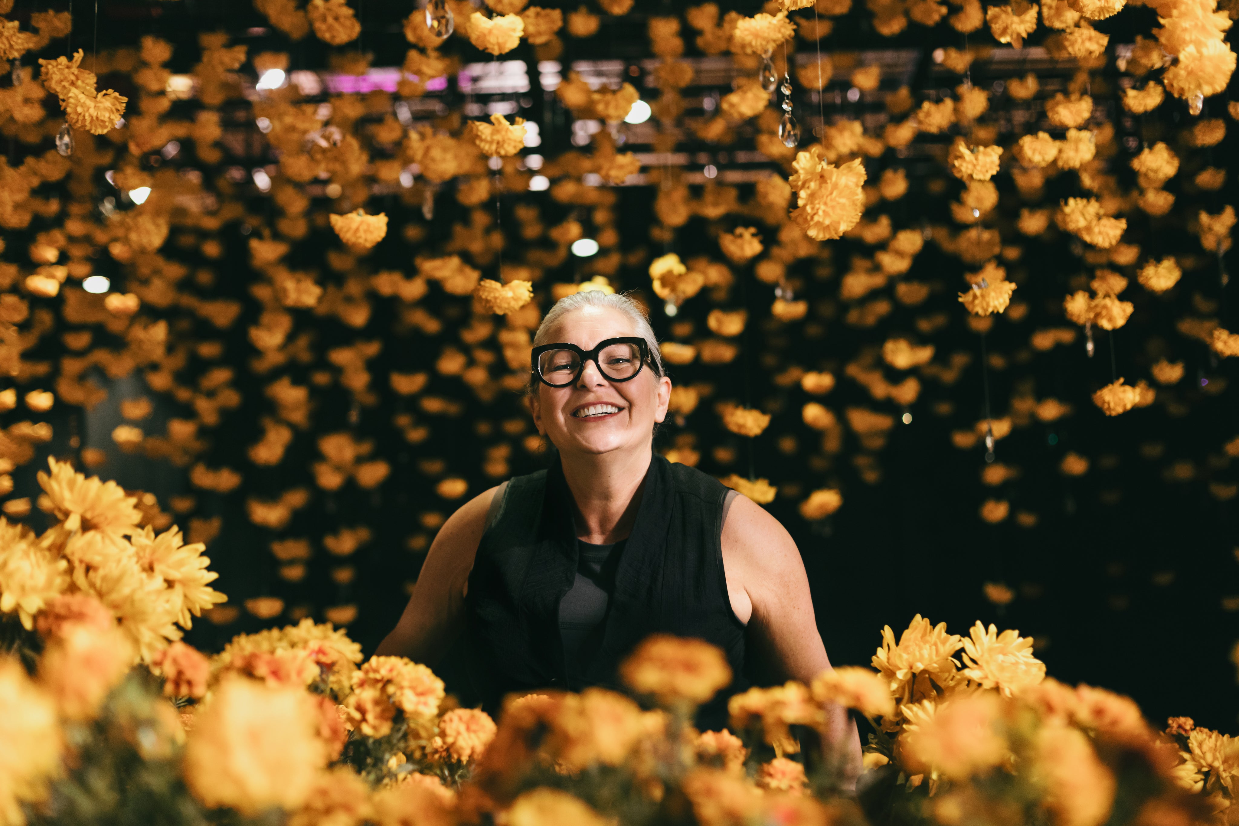 files/women-peeking-over-yellow-flowers.jpg